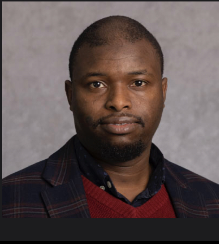 Head-and-shoulders portrait of a man looking directly at the camera with a neutral expression.