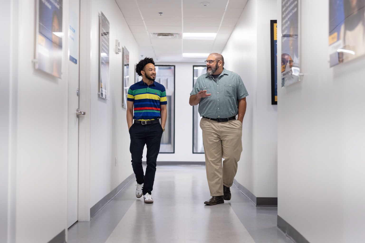 Men walking the hall of a school
