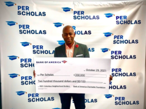 Check for Grant Award with Per Scholas Managing Director Noah Mitchell holding the check.