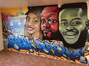 mural of graduates with South Bronx painted on the bottom.