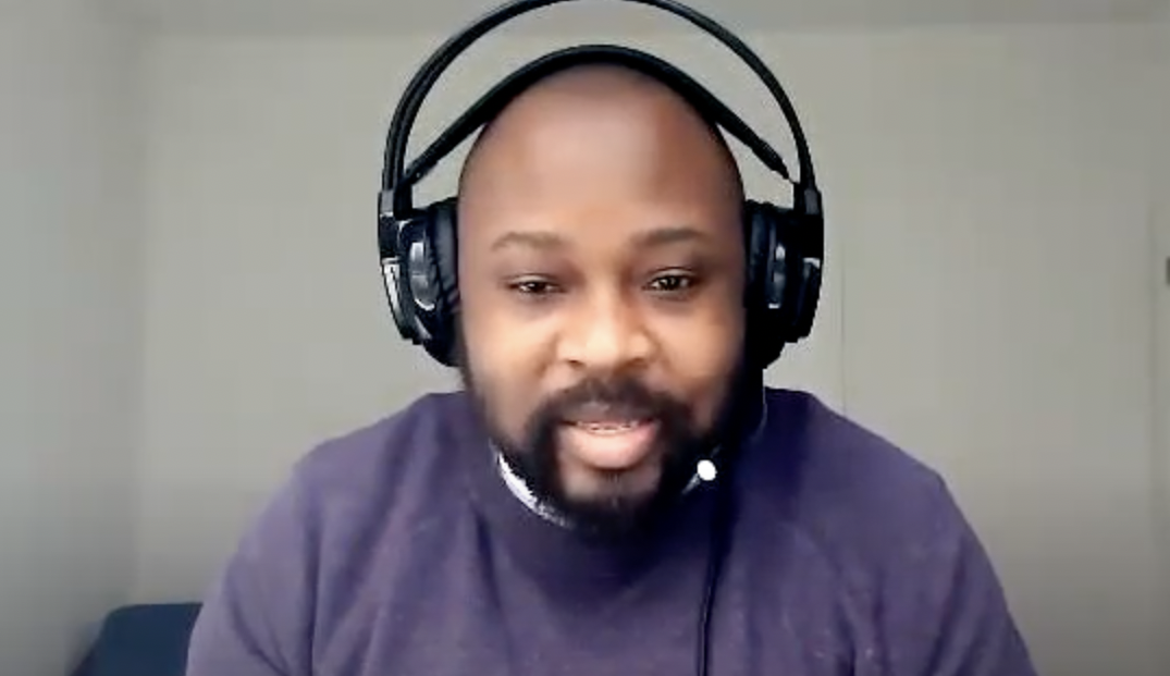 Serge Mavuba wearing headphones in his interview on mental health
