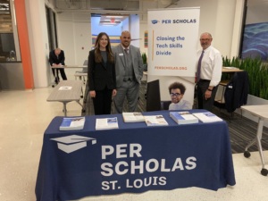 Per Scholas St. Louis table with team members standing behind it